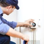 Technician repairing a hot-water heater